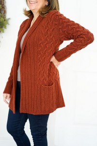 Oversized cardigan with all-over cable texture and shawl collar, designed by Lori Versaci.