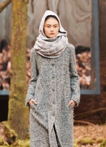 Chanel purple, grey and ecru scarf worn wrapped around neck and over head as hood.