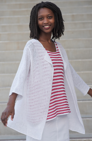 Woman wearing red/white striped top with a white skirt and a long, sheer, knitted cardigan made from white linen.